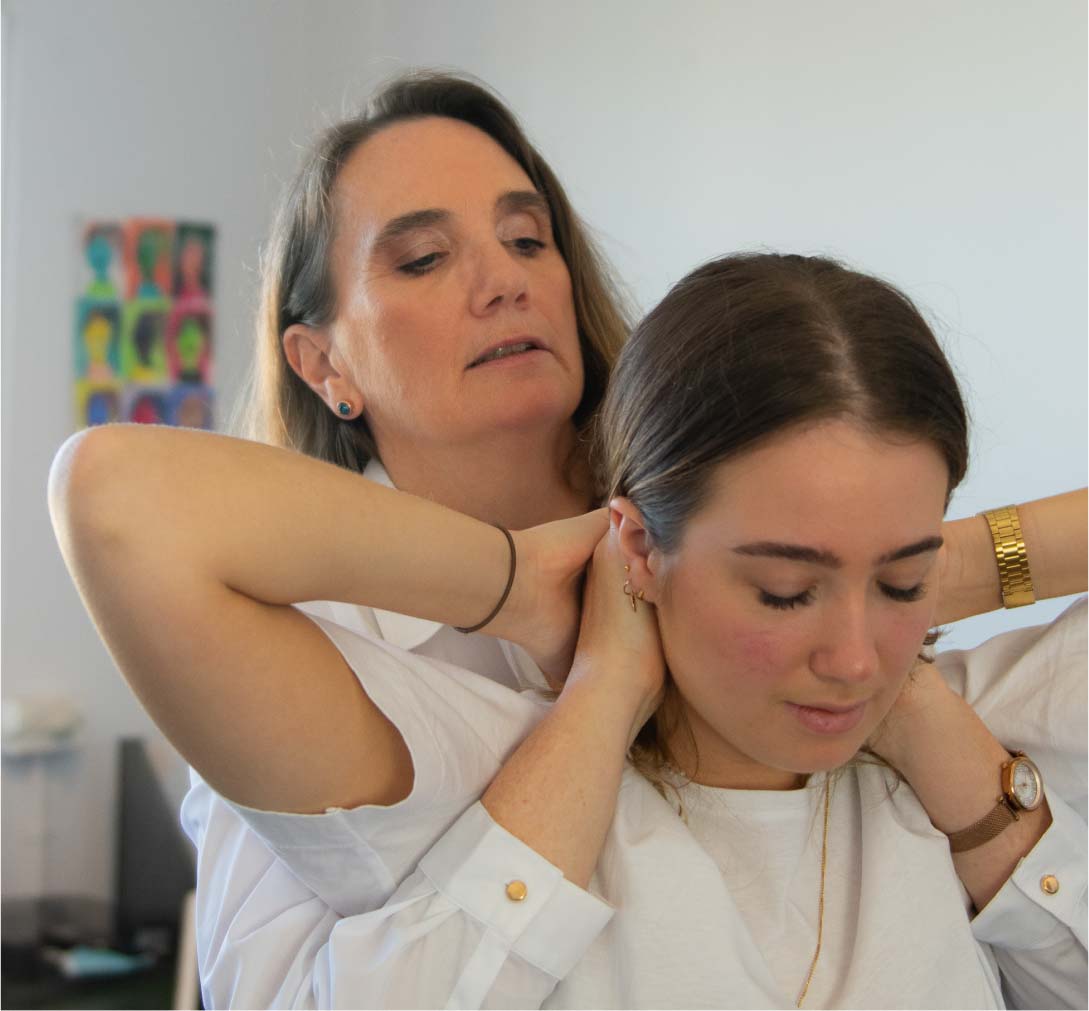 Dr Kate Willesee helping care for a patient and their neck with chiropractor techniques