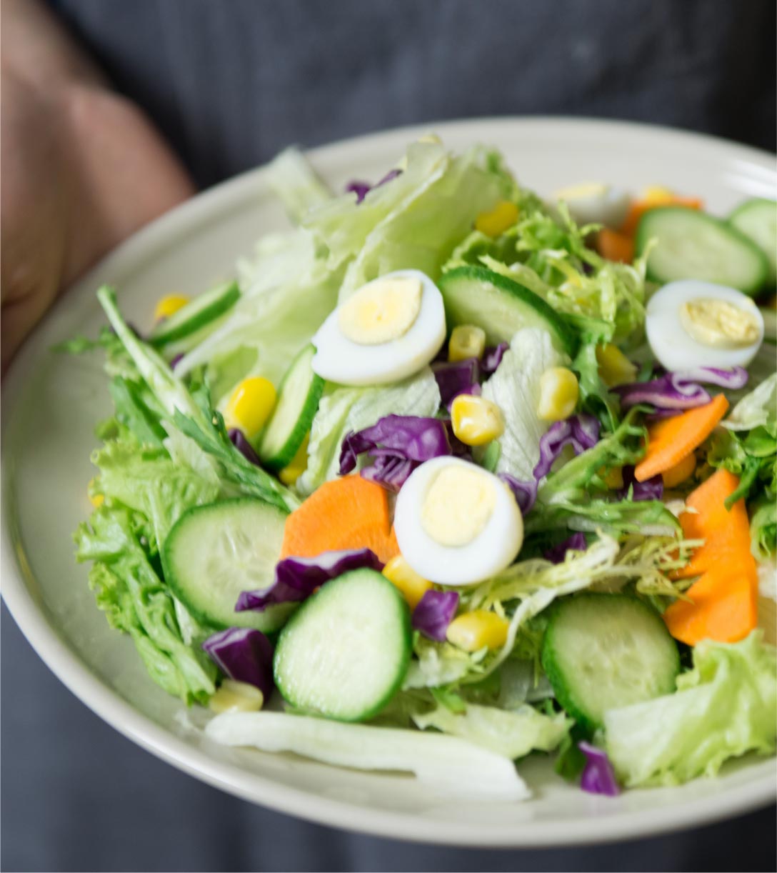 A bowl of fresh salad with mixed greens and vegetables